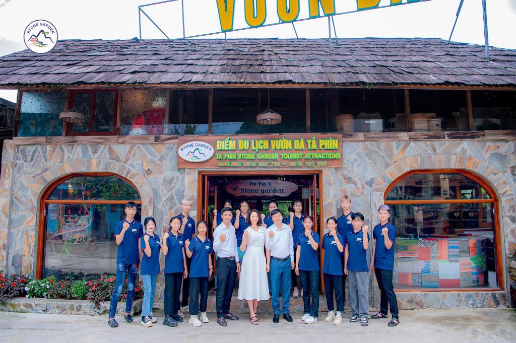 a group of people standing in front of a restaurant at Stone Garden Resort & Spa in Sa Pa