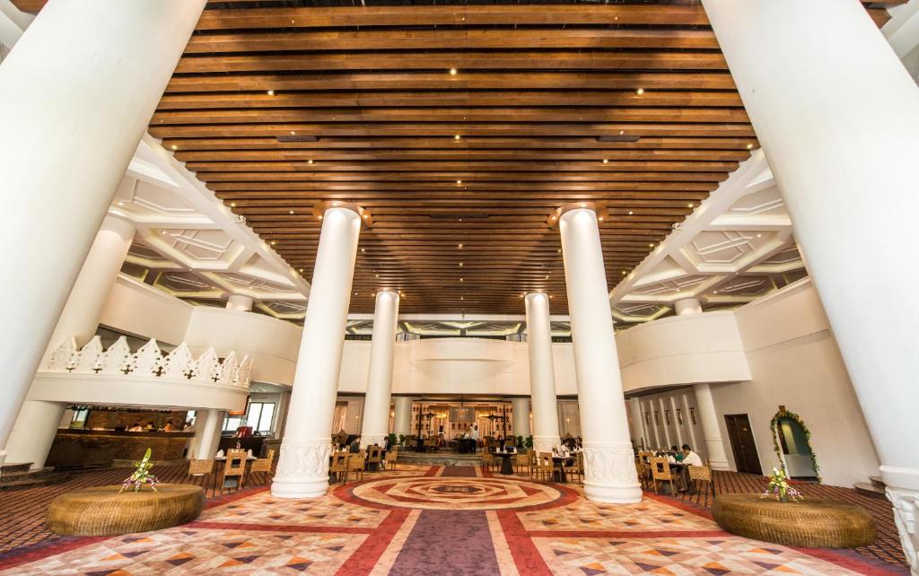 a view of the lobby of a building with columns at Rose Garden Hotel in Yangon