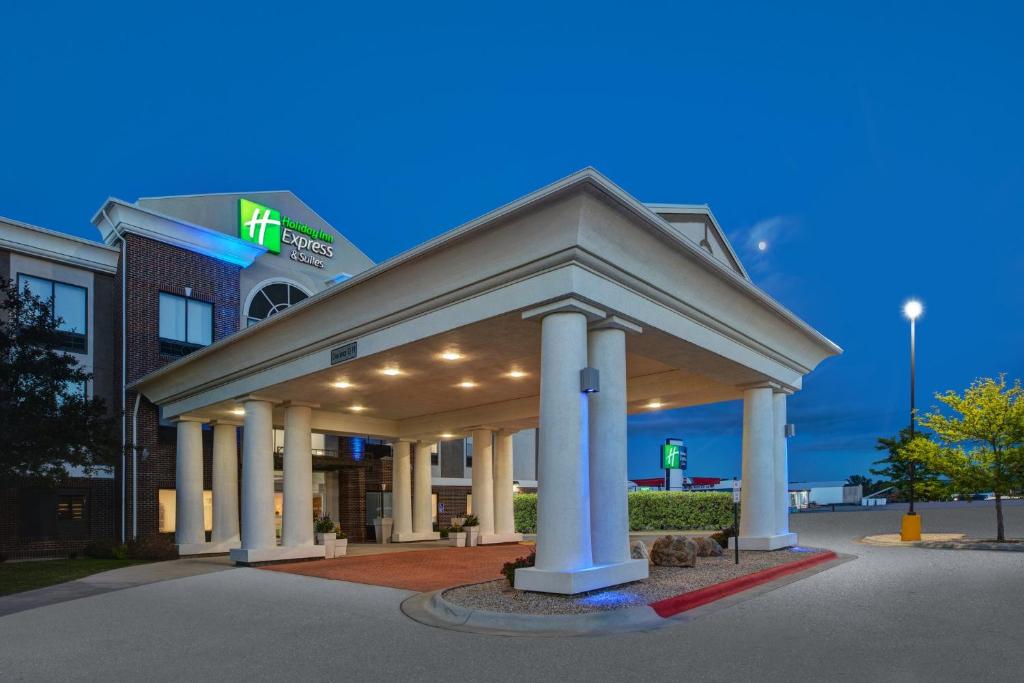 a hotel with a building with pillars in front of it at Holiday Inn Express & Suites Buffalo by IHG in Buffalo