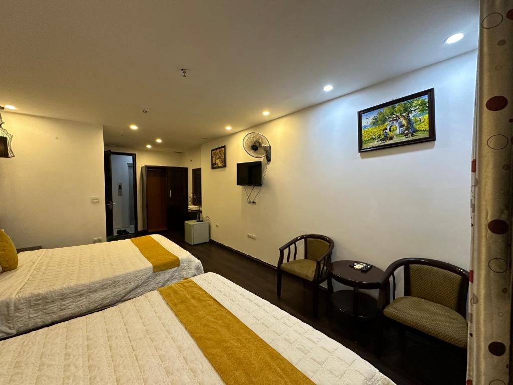 Postel nebo postele na pokoji v ubytování Hanoi Cozy Legend Hotel