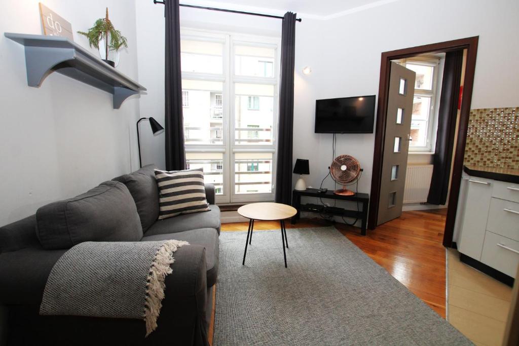 a living room with a couch and a table at Apartment Classic Comfort in Elblag
