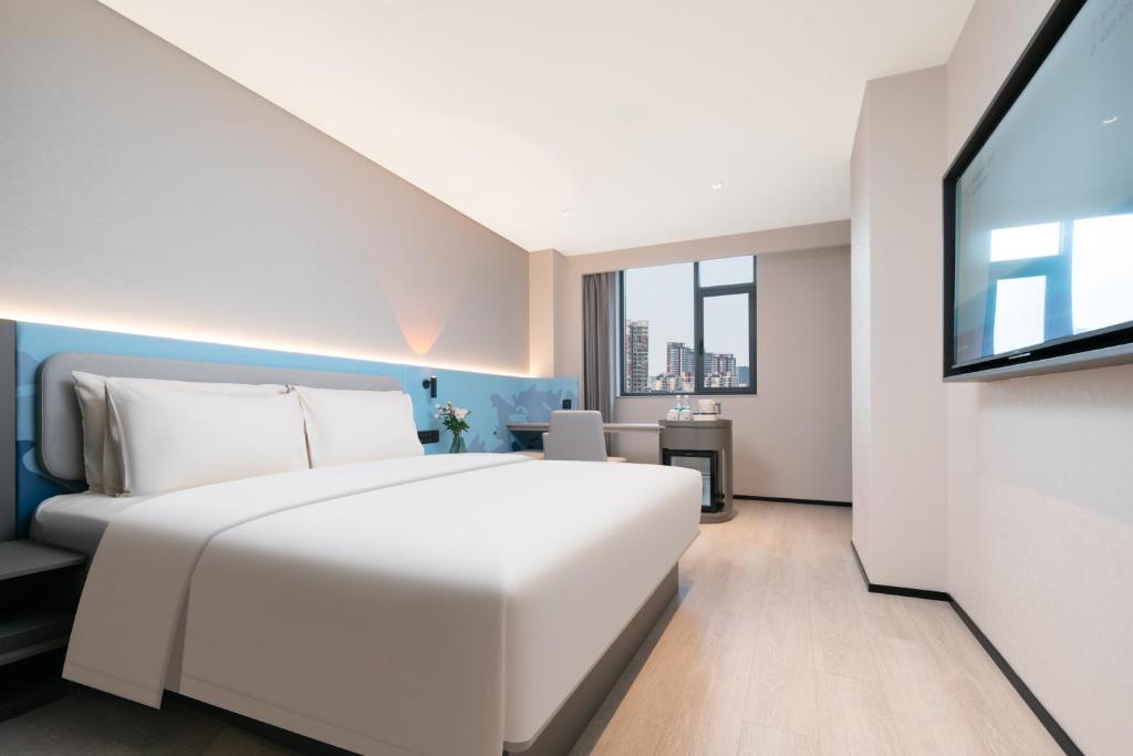 Voodi või voodid majutusasutuse Atour Light Hotel Wuhan Wanxiang City Xinhua Road toas