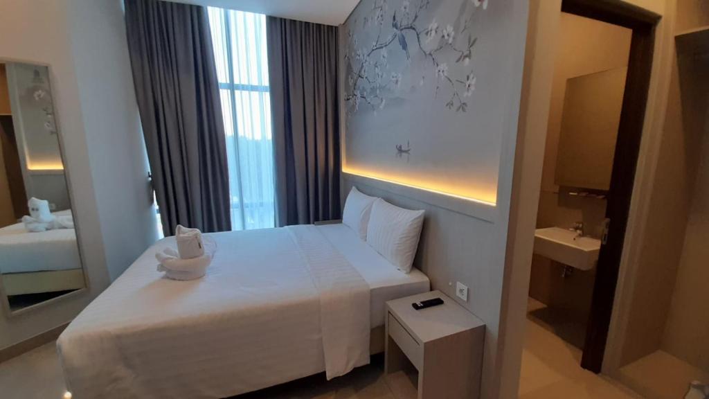 Postel nebo postele na pokoji v ubytování Nemuru Grand Suites