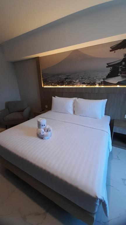 Postel nebo postele na pokoji v ubytování Nemuru Grand Suites