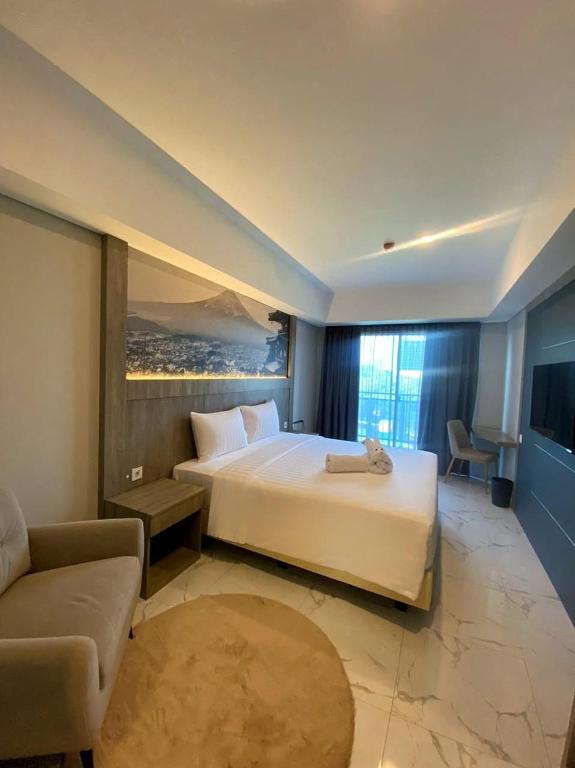 Postel nebo postele na pokoji v ubytování Nemuru Grand Suites