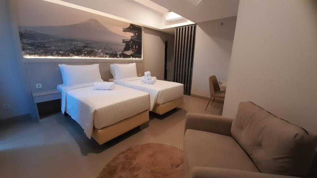 Postel nebo postele na pokoji v ubytování Nemuru Grand Suites
