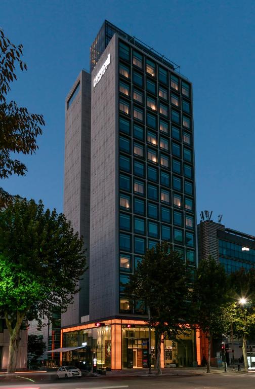 a tall building with a sign on the side of it at Hotel Cappuccino in Seoul