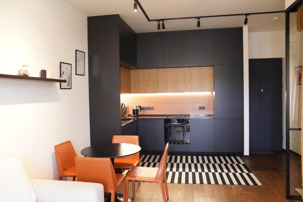 a kitchen and dining room with a table and chairs at Krtsanisi Grande apartment in Tbilisi City