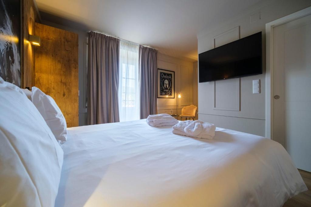 Postel nebo postele na pokoji v ubytování Azores Book Hotel