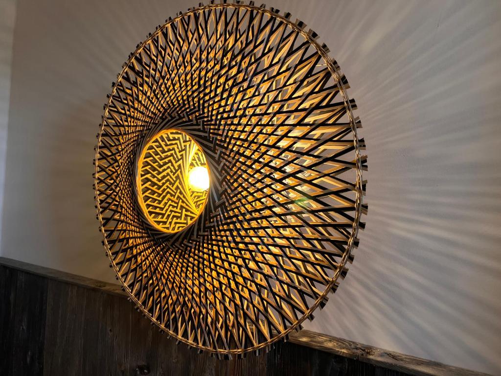 a spiral staircase with a light in the middle at VILLA am Paulsberg mit Sauna - V4 in Braunlage