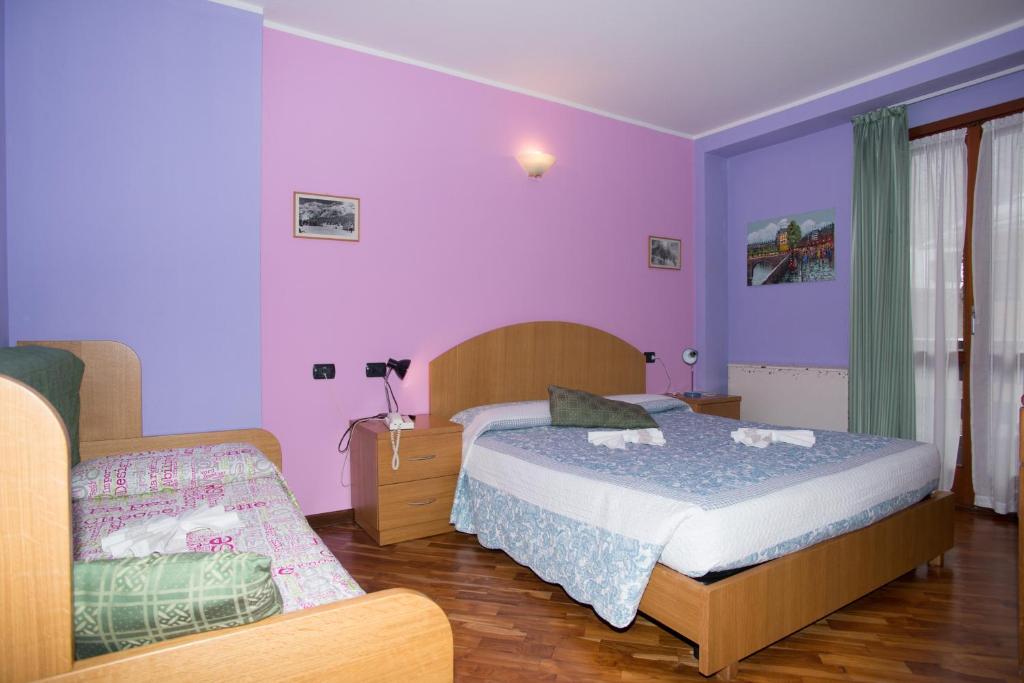 Postel nebo postele na pokoji v ubytování Hotel Pigna D'Oro