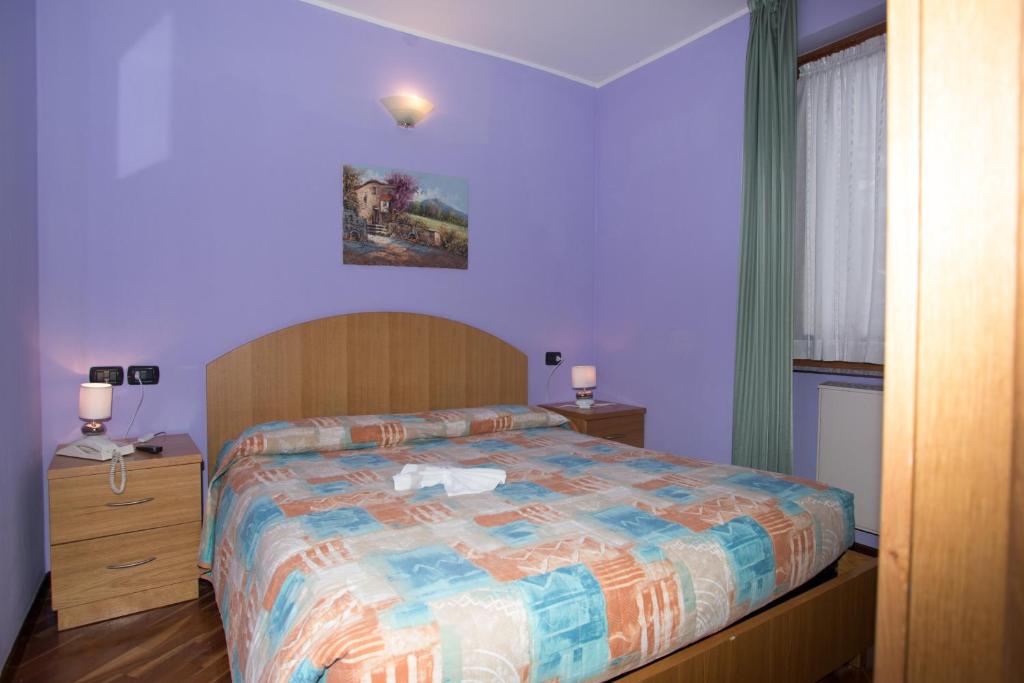 Postel nebo postele na pokoji v ubytování Hotel Pigna D'Oro