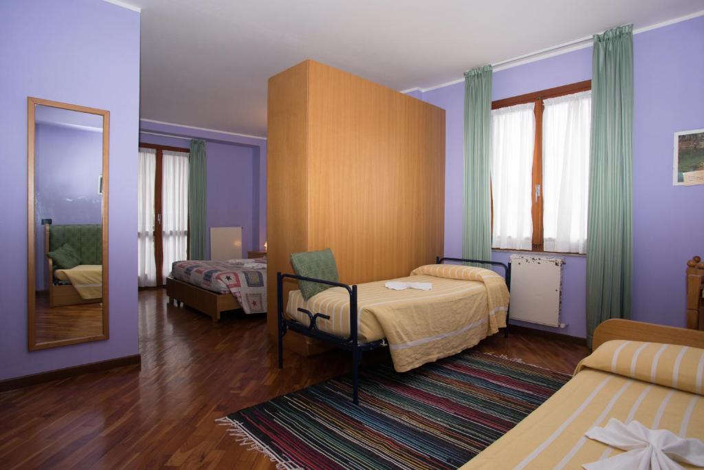 Postel nebo postele na pokoji v ubytování Hotel Pigna D'Oro