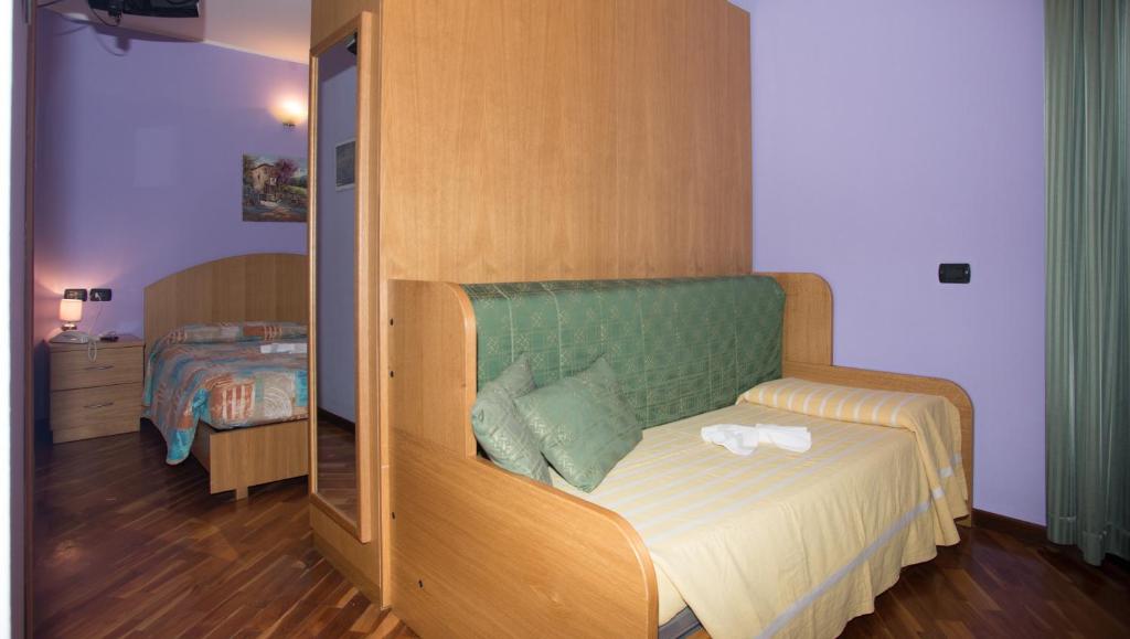 Postel nebo postele na pokoji v ubytování Hotel Pigna D'Oro