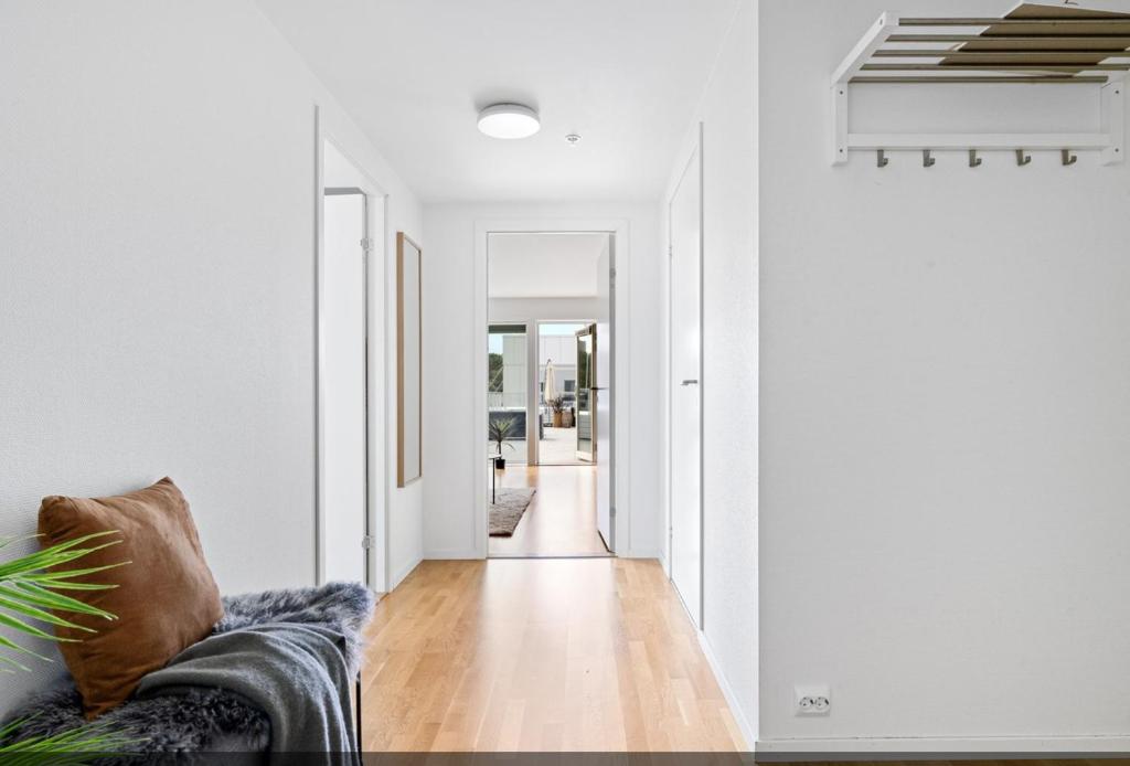 a living room with a couch and a hallway at Lervigbrygga 178b in Stavanger