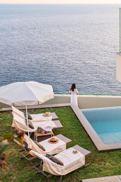 a woman standing on the deck of a cruise ship at Islander - Funchal Seaside Villas in Funchal
