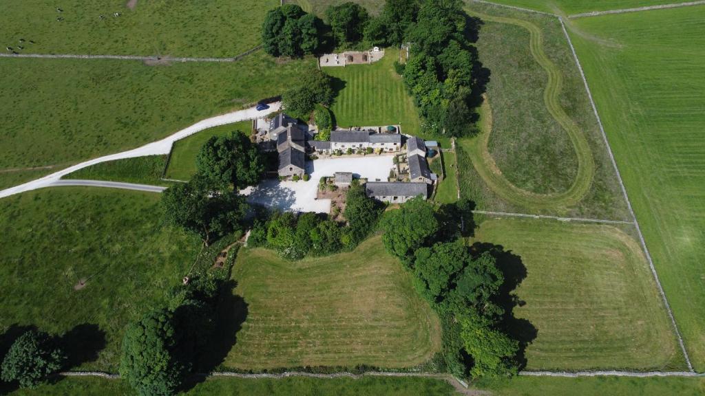 an aerial view of a mansion in a field at Bolehill Farm Cottages in Bakewell