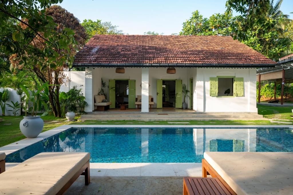 a villa with a swimming pool and a house at Zen Villa in Ahangama