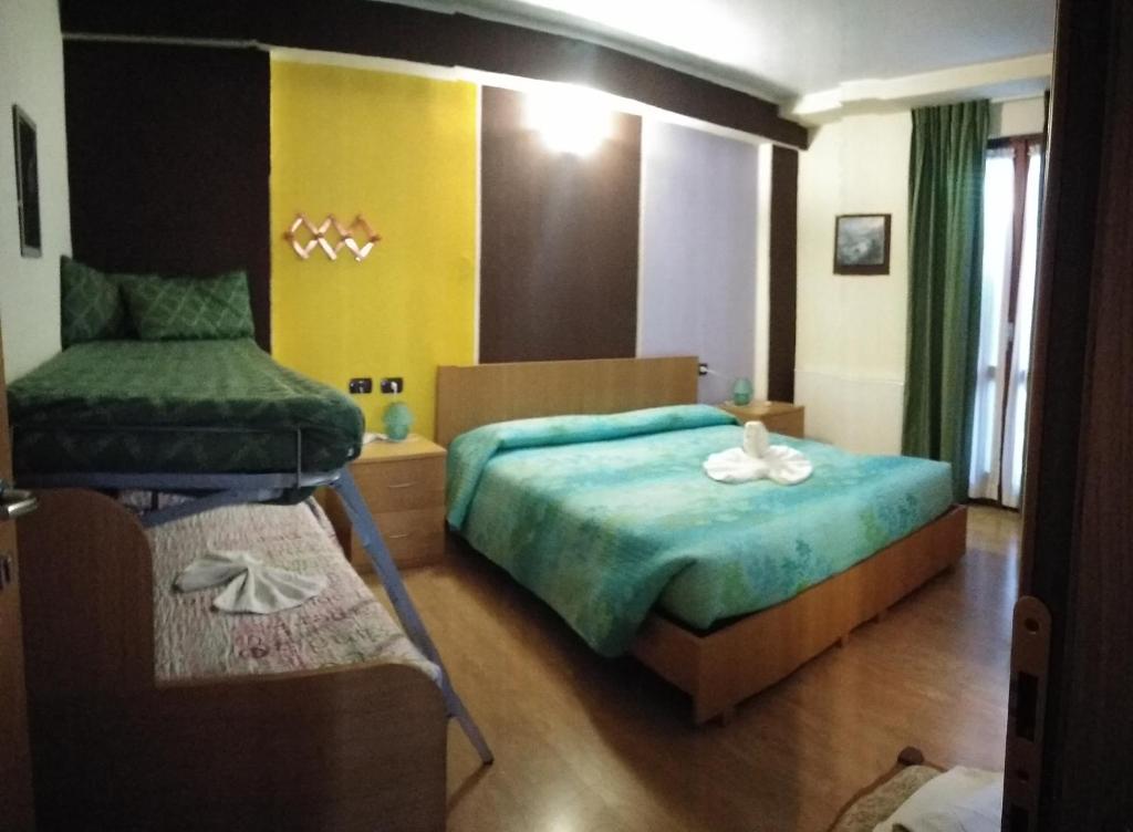 Postel nebo postele na pokoji v ubytování Hotel Pigna D'Oro