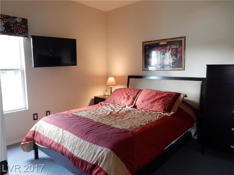 a bedroom with a bed and a flat screen tv at Southwest Retreat - Stylish Room with Queen Bed, Fast Wi-Fi & More! in Las Vegas