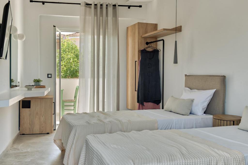 Postel nebo postele na pokoji v ubytování Ecoresort Hotel Zefyros