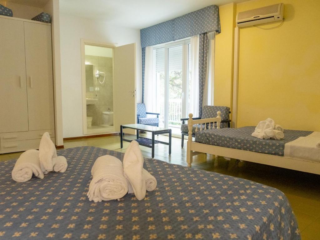 Postel nebo postele na pokoji v ubytování Family Hotel Alexander - Azzurro Club