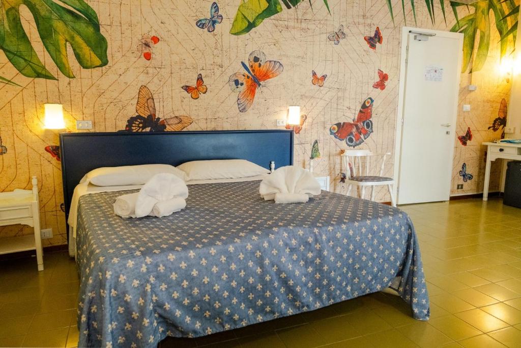 Postel nebo postele na pokoji v ubytování Family Hotel Alexander - Azzurro Club