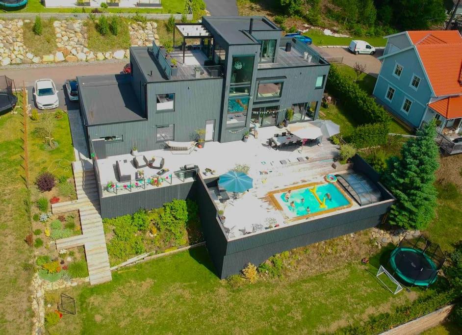 an aerial view of a house with a swimming pool at Large pool villa, roof terrace near lake & nature in Floda