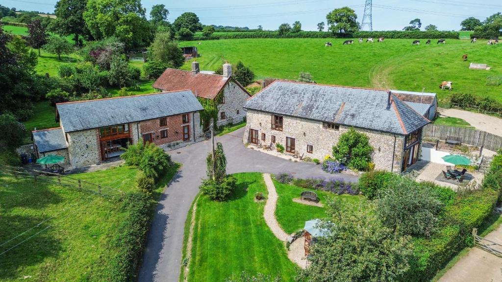 an aerial view of an old house and a farm at Hawley Farm in Hawley Bottom