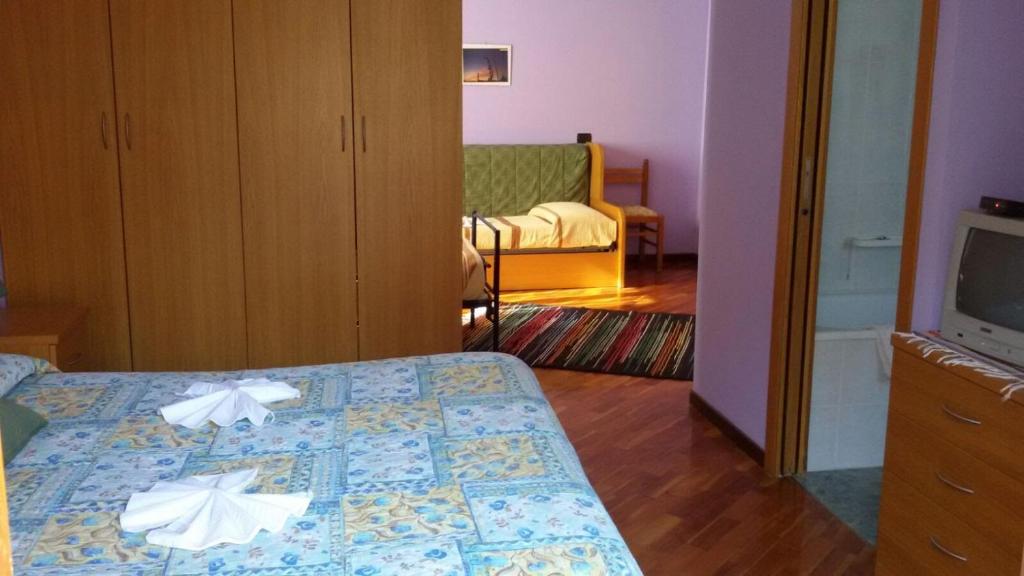 Postel nebo postele na pokoji v ubytování Hotel Pigna D'Oro