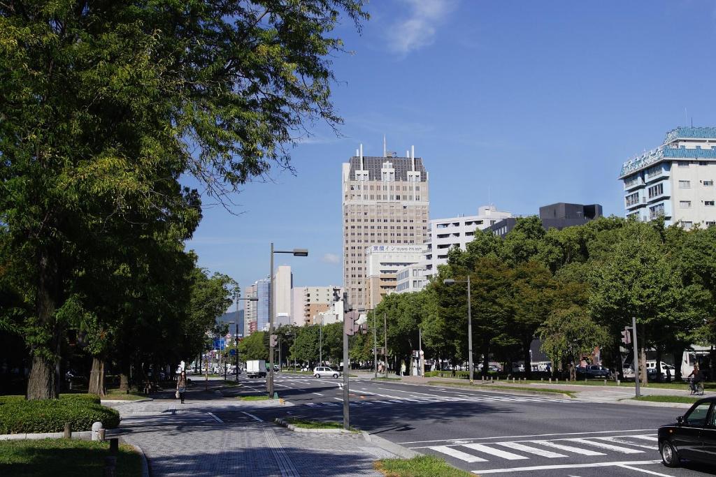 an empty street in a city with tall buildings at Oriental Hotel Hiroshima in Hiroshima