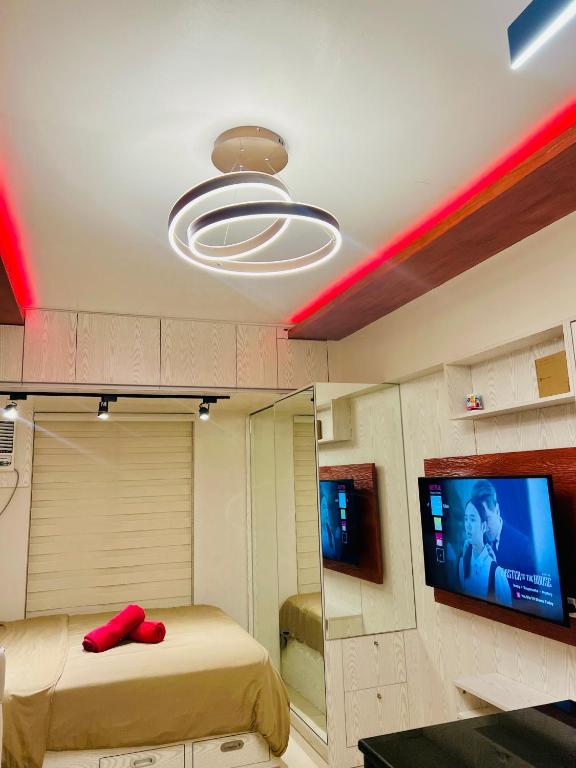 a room with a bed and a flat screen tv at Avida Towers Riala Tower inside IT Park Cebu City in Cebu City