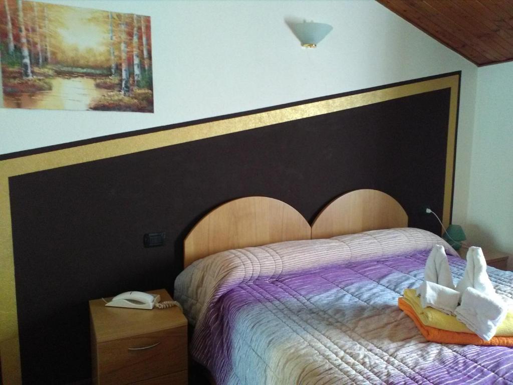 Postel nebo postele na pokoji v ubytování Hotel Pigna D'Oro