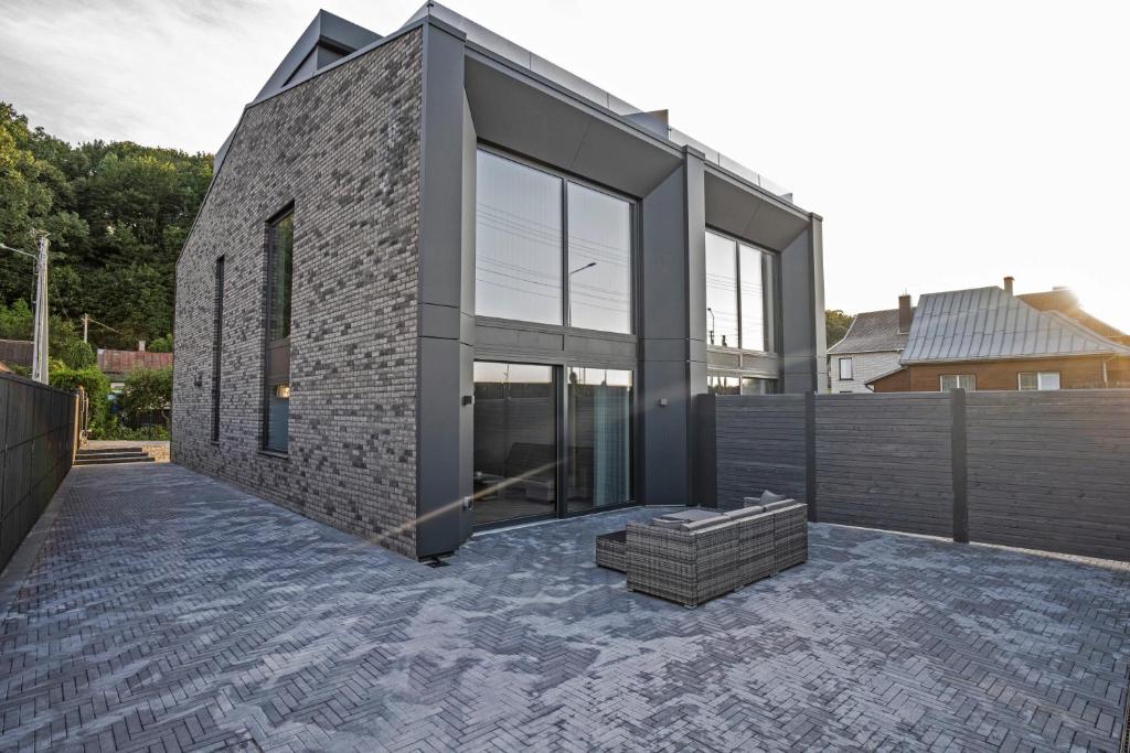a brick house with glass doors on a patio at MARVEL apartamentai in Kaunas