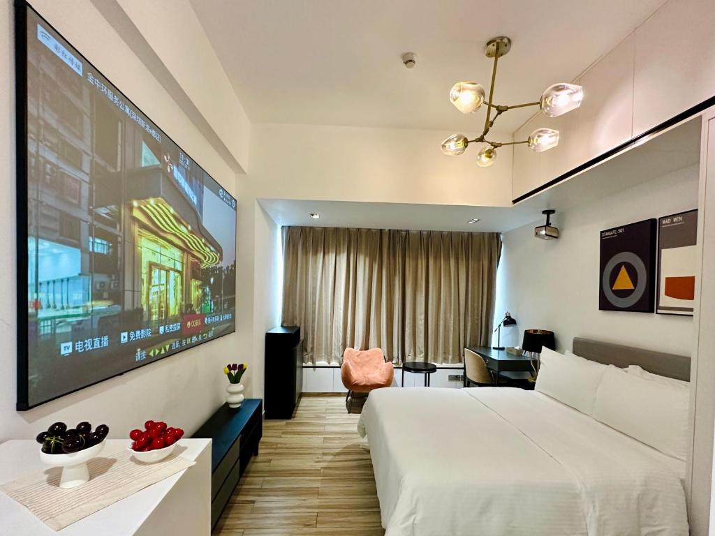 Postel nebo postele na pokoji v ubytování Golden Central Hotel Serviced Residence-Xin Hao E Du金中环服务公寓新浩e都店