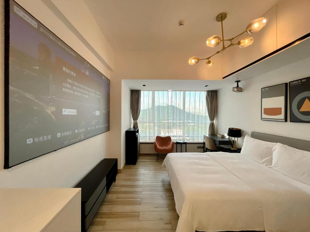 Postel nebo postele na pokoji v ubytování Golden Central Hotel Serviced Residence-Xin Hao E Du金中环服务公寓新浩e都店