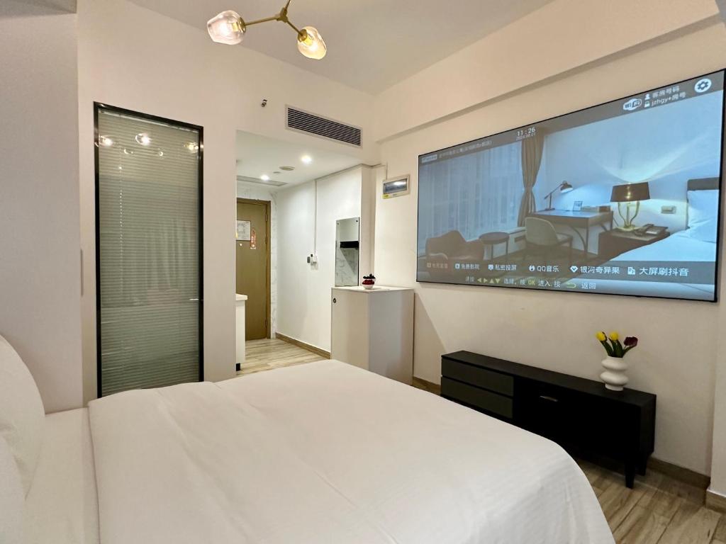 TV a/nebo společenská místnost v ubytování Golden Central Hotel Serviced Residence-Xin Hao E Du金中环服务公寓新浩e都店