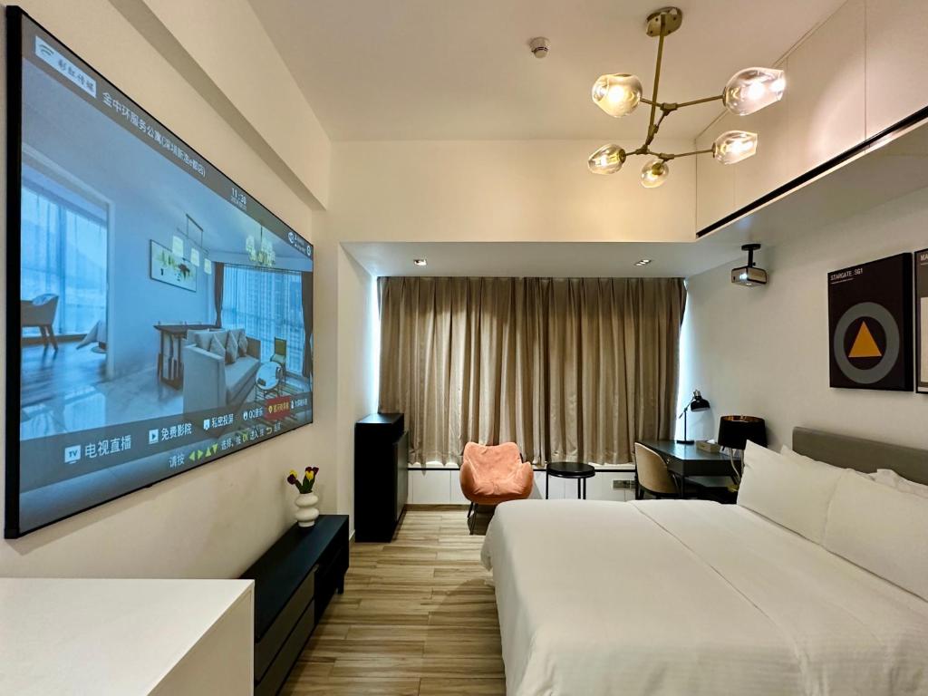 Postel nebo postele na pokoji v ubytování Golden Central Hotel Serviced Residence-Xin Hao E Du金中环服务公寓新浩e都店