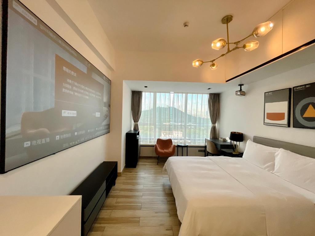 Postel nebo postele na pokoji v ubytování Golden Central Hotel Serviced Residence-Xin Hao E Du金中环服务公寓新浩e都店
