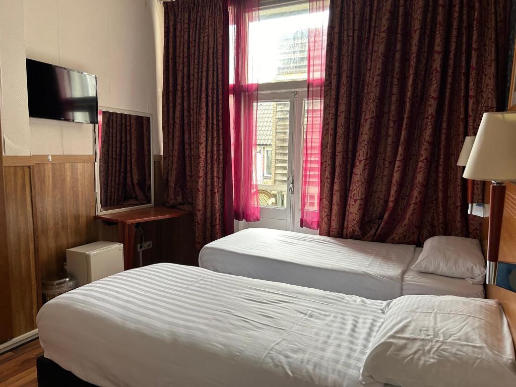 Postel nebo postele na pokoji v ubytování Hotel Isis