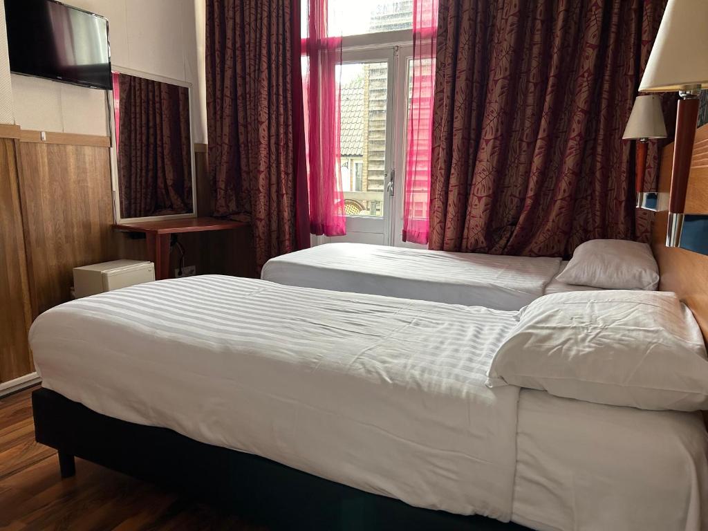 Postel nebo postele na pokoji v ubytování Hotel Isis