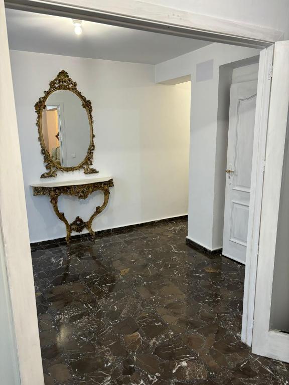 a hallway with a mirror and a marble floor at Casa Amparo in Jávea