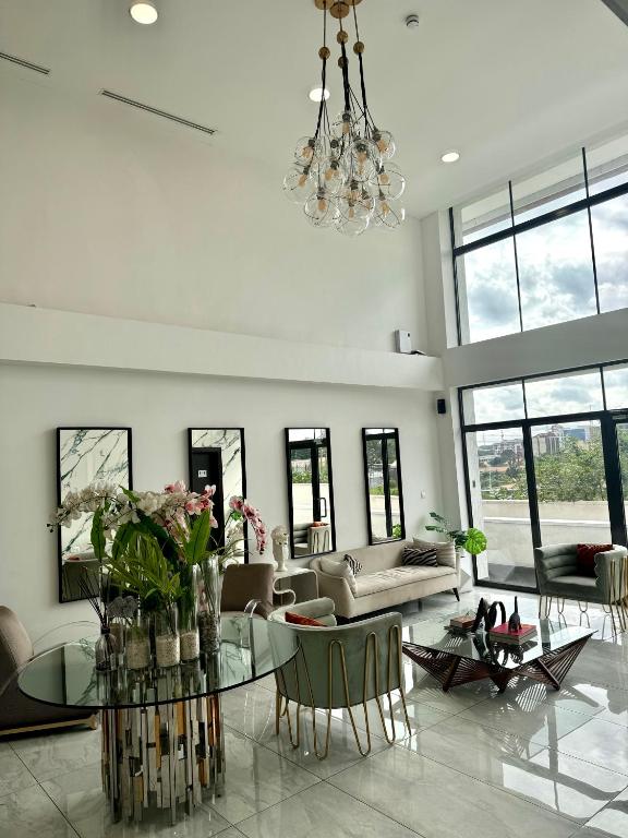 a living room with a couch and a glass table at Luxury Studio Suite 10 mins from Kotoka Airport Accra in Accra