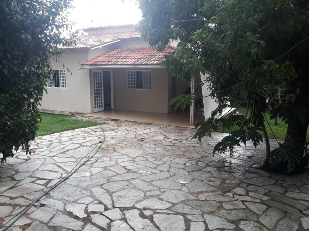 a stone driveway in front of a house at casa cachoeira in Brasília