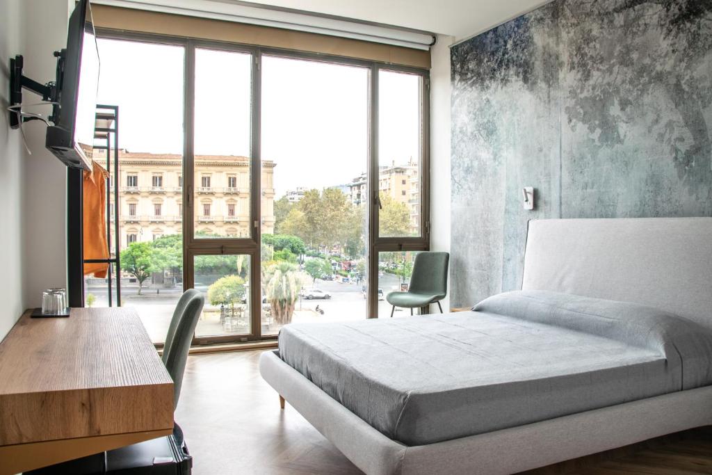 Ένα ή περισσότερα κρεβάτια σε δωμάτιο στο Politeama Crystal Rooms