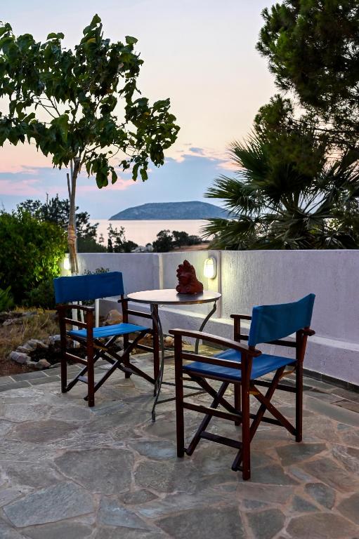 two chairs and a table and a table and chairs at morfo's sunset in Sounio