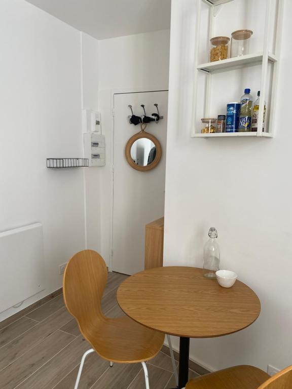 a dining room with a table and two chairs at Studio centre ville proche RER A wifi in Saint-Germain-en-Laye
