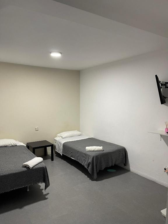 Posteľ alebo postele v izbe v ubytovaní Hostal Santa Calma
