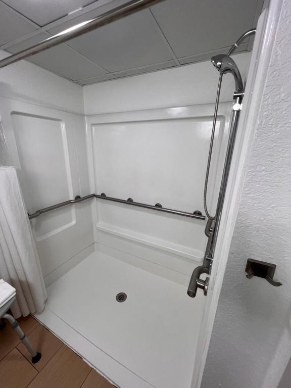 a small bathroom with a shower in a room at Country Inn & Suites by Radisson, Pigeon Forge South, TN in Pigeon Forge