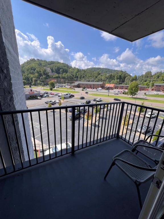 a balcony with a chair and a view of a parking lot at Country Inn & Suites by Radisson, Pigeon Forge South, TN in Pigeon Forge